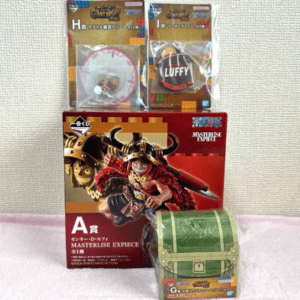 Boxed One Piece Masterlise EX figures with a red pirate-box art, plus two small collectible items in plastic packaging at the top and a small green treasure Chest figure in front.