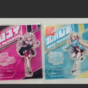 Two anime character acrylic standee boxes in pink and blue packaging, each featuring a girl illustration on a shelf.