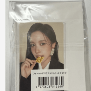 Front view of a packaged acrylic photo stand, showing a portrait of a woman biting a wafer, with a Japanese label and barcode on the card.