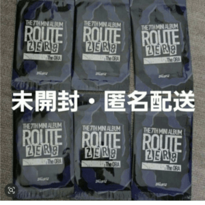 Six sealed blue camouflage bags labeled 'Route Zero' (The 7th Mini Album) arranged in a grid, with large white Japanese text across saying 'Unopened • Anonymous delivery'