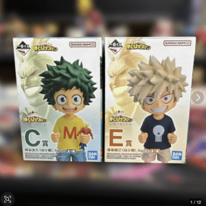 Two boxed My Hero Academia chibi figures side by side; left figure with green hair in a yellow shirt labeled 'C', right figure with light hair in a dark shirt labeled 'E', Bandai logos visible.