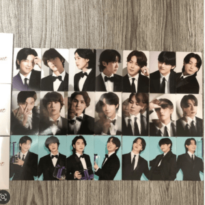 Set of small portrait cards showing men in tuxedos, arranged in three rows on a wooden table.
