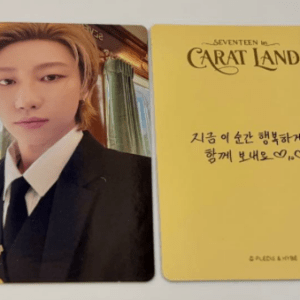 Two collectible cards: left card shows a portrait of a person in a black suit; right card is a yellow card with handwritten Korean text and 'CARAT LAND' branding.