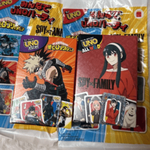 Two colorful UNO card packs with anime character art, including Spy x Family design, on a white surface.  Articulos Japan (Post Box Japan)
