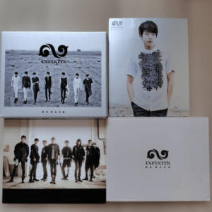 Four Infinite comeback album boxes laid on a flat surface: top-left grayscale desert photo with the Infinite logo, top-right portrait of a young man in a white shirt, bottom-left group photo in sunlight, bottom-right plain white box with the Infinite logo and 'Be Back' text.