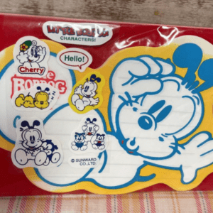 Sticker sheet in red packaging featuring a large blue-outlined wave-waving cartoon dog and several small character stickers inside a yellow border.