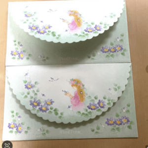 Pastel green cards with scalloped edges, a girl with a flower crown, and purple flowers surrounding birds. Theme looks like floral poem stationery.