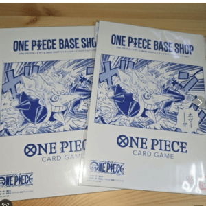 Two white One Piece Card Game booklets overlapping, with blue manga art and 'ONE PIECE BASE SHOP' header.