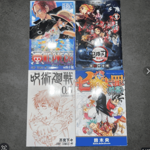 Four manga volumes laid flat on a dark carpet, arranged in a 2x2 grid; top-left is One Piece, top-right is Demon Slayer, bottom-left a white-page manga with Japanese title, bottom-right blue-cover manga with a blond hero.