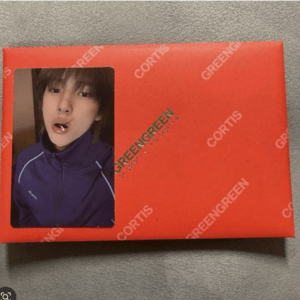 Red packaging box with a photo of a young person in a purple jacket in a rounded window on the left side.