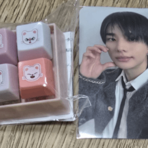 Pastel erasers with cute cat faces in a plastic-wrapped pack next to a glossy photo card of a young man in a suit.  Articulos Japan (Post Box Japan)