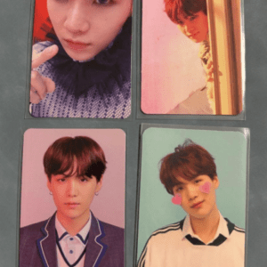 Set of four portrait photo cards showing a young man in different outfits: top-left close-up in a dark knit; top-right peeking from behind a door with a pink background; bottom-left in a purple blazer; bottom-right smiling with pink heart stickers on cheeks against a mint background.