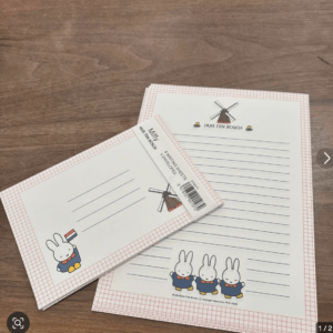 Letter-sized notepaper with a windmill logo and 'HUIS TEN BOSCH' branding, decorated with Miffy characters at the bottom and blue ruled lines for writing.