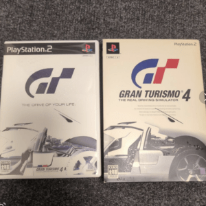 Two PlayStation 2 game cases for Gran Turismo 4 placed side by side, with 'The Drive of Your Life' on the left and 'The Real Driving Simulator' on the right.