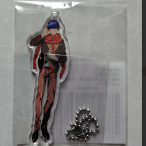 Acrylic anime-style figure in clear packaging, featuring a tall man with blue hair, red scarf, and brown suit, plus a metal ball-chain keyring.