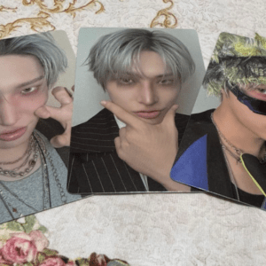 Three photo cards showing a person with silver-gray hair posing in different ways on a light patterned surface with floral touches.