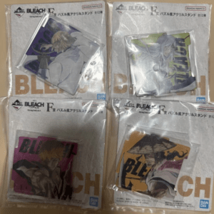 Four Bleach acrylic stand figures in sealed packaging, each with different character artwork and colors.