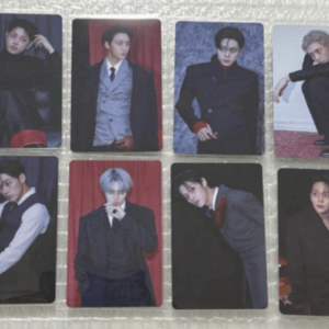 Eight glossy photo cards featuring male K-pop idols in formal outfits, arranged in two rows on a textured surface.