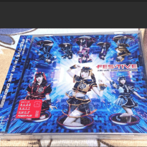 CD case featuring five anime-style performers in blue-black costumes on a bright blue digital background; prominent 'FESTIVE' logo and group artwork on the cover.  Articulos Japan (Post Box Japan)