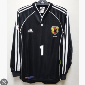 Japan national football team jersey, black with white stripes, number 1, crest and Adidas logos visible