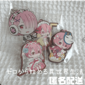 Set of pink-haired anime-style chibi keychains in plastic packaging on a white quilted background.