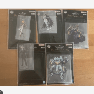 Five boxed Overlord acrylic stand figures still in plastic packaging laid out on a wooden table