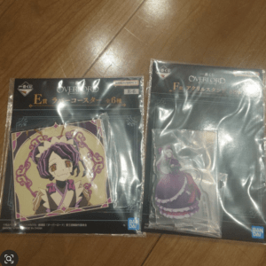 Two packaged Overlord figurine sets on a wooden surface; left shows a purple-haired character illustration, right shows a purple-dressed character.