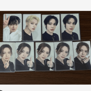 Ten photocard prints laid on a wooden surface; top row shows four individual portraits, bottom row six portraits of the same woman giving a thumbs up.